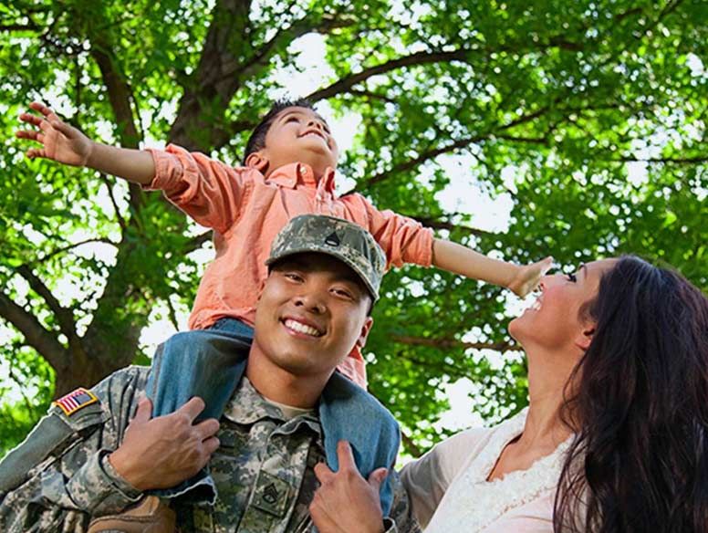 Veteran with family smiling outside